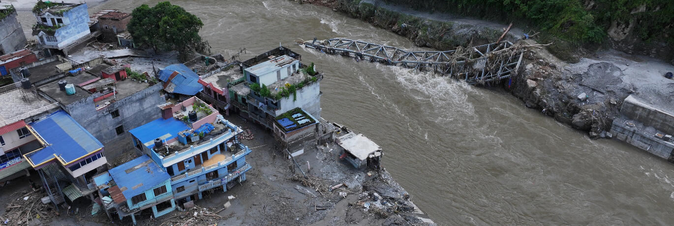 Aerial view of a collapsed bridge over the Trishuli River.