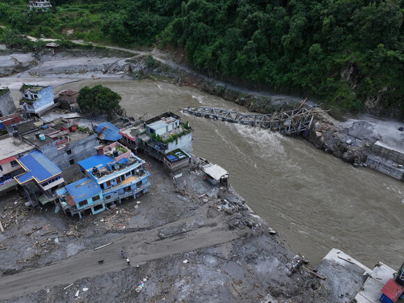 Aerial view of a collapsed bridge over the Trishuli River.