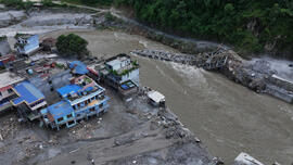 Aerial view of a collapsed bridge over the Trishuli River.